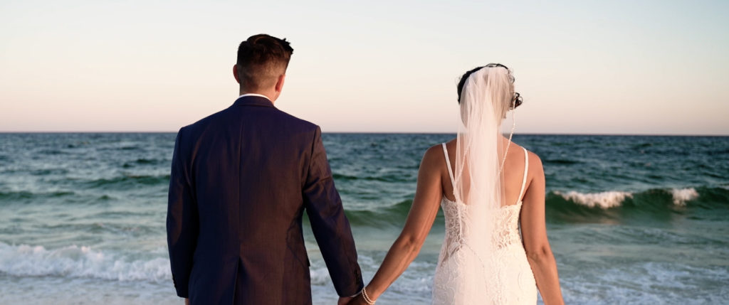 Alabama wedding bride in Gulf Shores gazing at ocean.